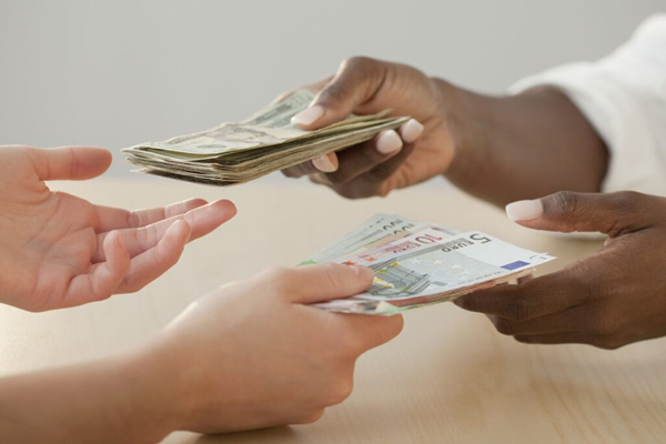 Hand holding Euro banknotes